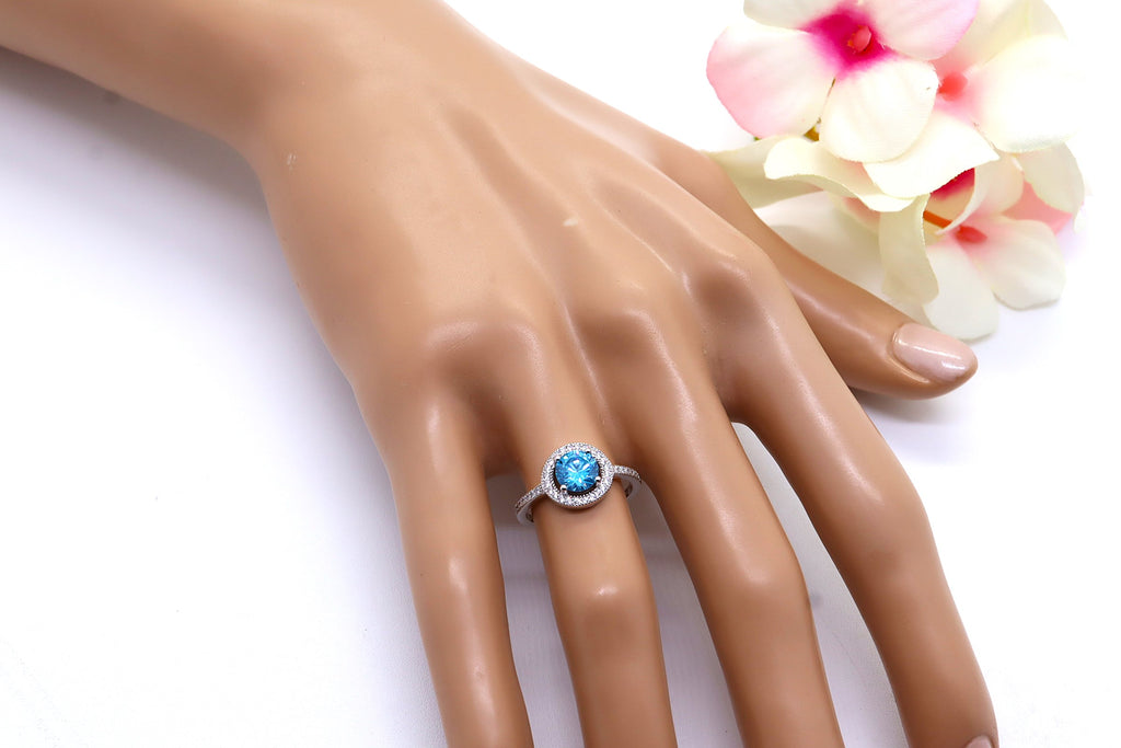 Anillo Plata 925mls Circonita central Azul y circonitas blancas